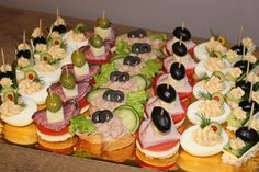 an assortment of appetizers are arranged on a platter, ready to be eaten