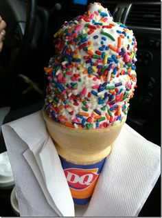 an ice cream cone filled with sprinkles and colored candy