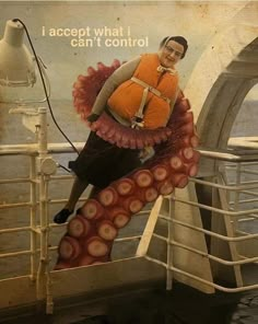 a man in an orange life jacket is on the side of a boat with an octopus