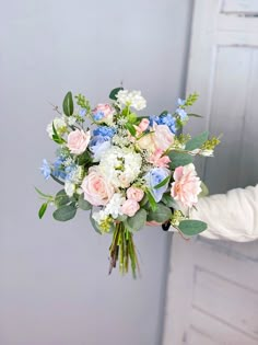 a person holding a bouquet of flowers in their hand