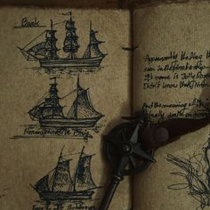 an open book with drawings on it and a pair of old scissors in the middle