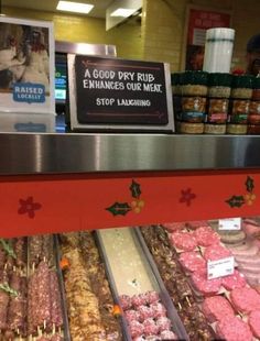 an assortment of meats on display in a store