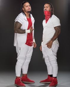 two men dressed in white and red standing next to each other