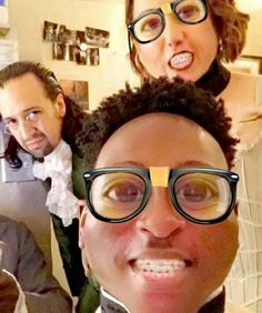 three people wearing glasses and bow ties are taking a selfie in front of the camera