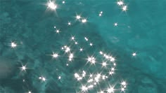 an aerial view of stars floating in the water