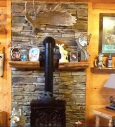 there is a wood stove in the corner of this room with deer heads on the wall