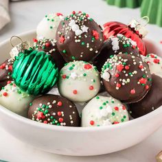 a white bowl filled with chocolate covered christmas ornaments