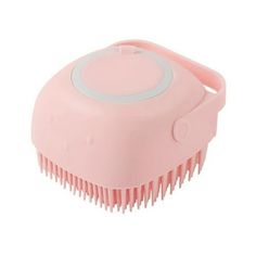 a pink hair brush sitting on top of a white surface