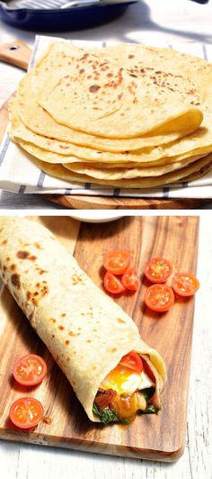 there are several different types of tortillas on the cutting board, and one is cut in half