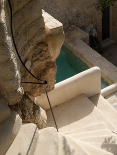 an outdoor swimming pool surrounded by stone steps