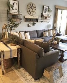 a living room filled with lots of furniture next to a large clock on the wall