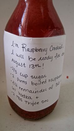 a jar of raspberry coulie is shown with a note attached to it