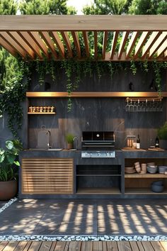 an outdoor kitchen with grill, sink and potted plants