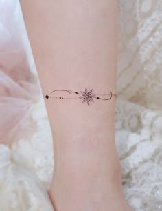 a woman's foot with a small tattoo on the left side of her leg