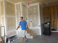 a man walking through a room under construction