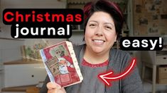 a woman holding up a christmas journal in front of her face with the words, christmas journal easy