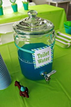 a table topped with a jar filled with blue liquid