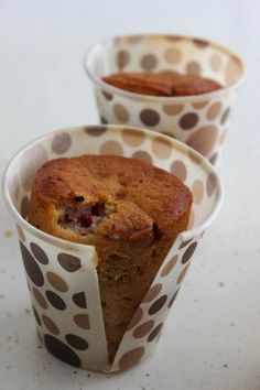 three cups with muffins in them on a table