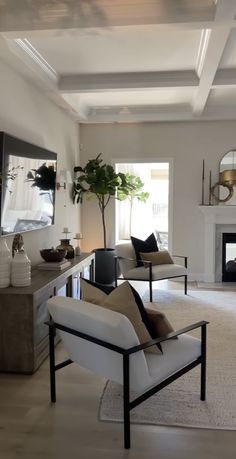 a living room filled with furniture and a fire place in the middle of the room