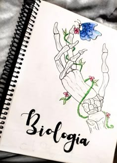 a notebook with the word biologia written in black ink on top of it