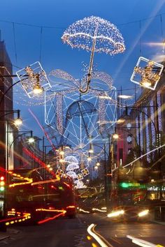 a city street filled with lots of lights and decorations