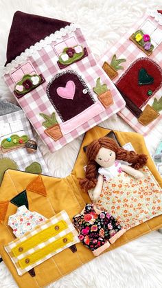 several handmade dolls are laying next to each other on a white furnishing