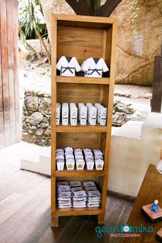 a wooden shelf filled with lots of white towels