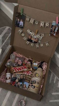 an open box with pictures and other items in it sitting on top of a floor