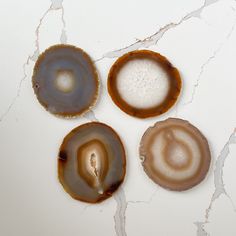 three different types of agate beads on a white surface with cracks in the middle