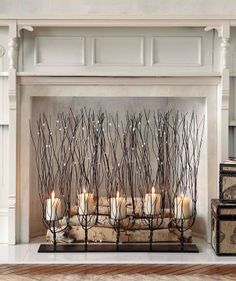 candles are lined up in front of a fireplace with branches on it and the words pint written above them