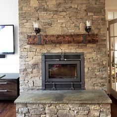 a stone fireplace with two lights on each side