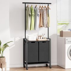 a laundry room with clothes hanging on the rack