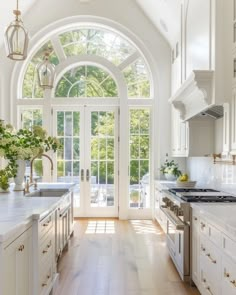 a kitchen with an arched ceiling and white cabinets