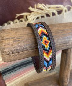 a bracelet is sitting on top of a wooden stand