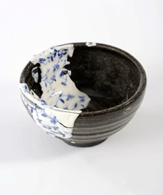 a black and white bowl with blue flowers on it