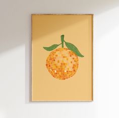 an orange with green leaves on it is mounted to the wall