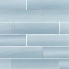 a white brick wall with light blue tiles