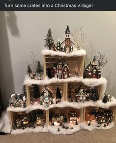 a christmas village made out of wooden shelves with snow on the top and houses in the bottom