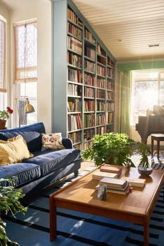 a living room filled with furniture and lots of books