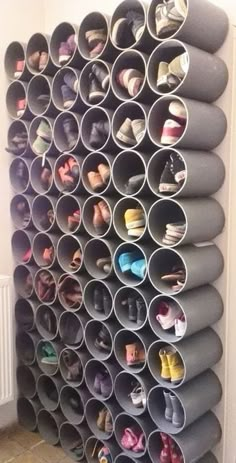 an organized shoe rack with many pairs of shoes on it and several rows of them