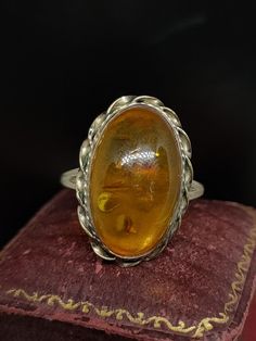 This stunning vintage ring has a statement design featuring a large natural vibrant orange cabochon amber gemstone set in 9ct yellow gold hallmarked Sheffield 1994  UK size - R UK size - 8.75  Message me any questions  Message me any questions  ITEM - S1770 Vintage Yellow Gold Gemstone Cabochons, Oval Amber Cabochon Jewelry, Vintage Amber Jewelry With Polished Finish, Vintage Oval Cabochons For Formal Occasions, Vintage Round Gemstone Cabochons, Vintage Polished Cabochons For Formal Use, Vintage Yellow Gold Cabochons As Gift, Vintage Yellow Gold Cabochons For Gift, Classic Amber Oval Cabochon Jewelry