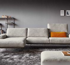 a modern living room with grey walls and furniture