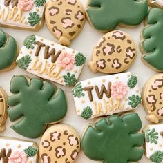 decorated cookies are arranged in the shape of flowers, leaves and letters that spell out wtw