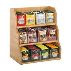 a wooden shelf filled with different types of teas and coffee bags on it's sides