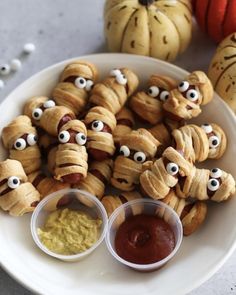 a white plate topped with croissants covered in googly eyes