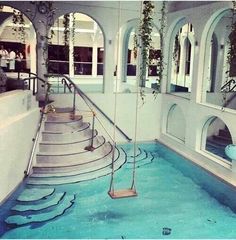 an indoor swimming pool with steps leading up to it