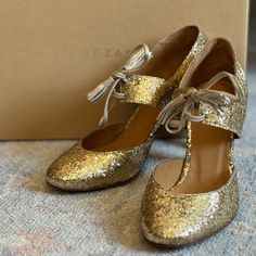 Stunning Glittery Gold Heels From Sezane, New Never Worn And Still Has The Plastic Liner Intact On The Bottom Soles! These Are Absolutely Positively Gorgeous. I’ve Had Them For Years And Sadly Never Wore Them. I’m Hesitant To Sell, But They Deserve To Be Worn And Loved! They Have An Old World, Vintage, Flapper Vibe To Them And They Definitely Have The Wow-Factor! Great For Weddings, New Years Eve, Or Your Next Formal Event. Euro 37, Best Fits Us 6.5/7. From A Smoke/Pet Free Home. Gold Shimmer Heels For Gala, Gold Glitter Closed Toe Wedding Shoes, Gold Closed Toe Wedding Shoes With Glitter, Elegant Sequined Block Heels, Gold Round Toe Heels For Festive Occasions, Elegant Glitter Wedding Shoes With Block Heel, Gold Glitter Wedding Shoes For Evening, Gold Glitter Heels For Gala, Elegant Gold Heels For Festive Occasions