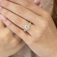 a woman's hand with a diamond ring on her finger and an engagement band