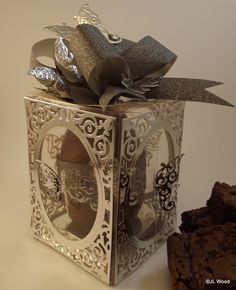 a silver box with a bow and some cookies