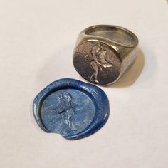 This signet ring is cast in lead-free pewter. The ring size when cast is 7.25. The sealing image is a figure embracing the moon.       This is part of a series of signet rings I am making cast from lead-free pewter. Each master ring is hand sculpted to give a unique, rustic style, multi-dimensional relief image when used as a stamp to seal, with sealing wax. Symbolic Round Hand Cast Signet Ring, Hand Cast Signet Ring As Gift, Class Rings College, 14k Gold Signet Ring, Class Rings High School, School Rings, College Rings, Ring Day, Pewter Ring